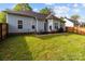 A spacious backyard featuring a well-maintained lawn, wooden fence, and patio area perfect for outdoor entertaining at 909 Jordans Pond Ln, Charlotte, NC 28214