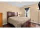 Bedroom with a neutral beige color scheme and a dark-stained wood furniture at 909 Jordans Pond Ln, Charlotte, NC 28214