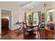 Charming dining room features a chandelier, round table, hardwood floors, and lots of natural light at 909 Jordans Pond Ln, Charlotte, NC 28214