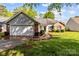 Charming single-story home features a brick and siding exterior, attached garage, and well-manicured front lawn at 909 Jordans Pond Ln, Charlotte, NC 28214