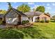 Charming single-story home features a brick and siding exterior, attached garage, and well-manicured front lawn at 909 Jordans Pond Ln, Charlotte, NC 28214