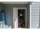 Close-up of a welcoming front door with a decorative wreath and blue 