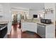 Bright kitchen featuring white cabinets, granite countertops, and stainless steel appliances at 909 Jordans Pond Ln, Charlotte, NC 28214