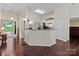 Open-concept kitchen with white cabinets, granite countertops, and access to the living area at 909 Jordans Pond Ln, Charlotte, NC 28214