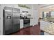 The kitchen boasts stainless steel appliances, granite countertops, and white cabinetry at 909 Jordans Pond Ln, Charlotte, NC 28214