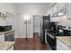 Well-lit kitchen featuring white cabinets, granite countertops, and stainless steel appliances at 909 Jordans Pond Ln, Charlotte, NC 28214