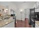 Well-lit kitchen features stainless appliances, granite countertops, and hardwood flooring at 909 Jordans Pond Ln, Charlotte, NC 28214