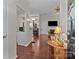 View into the living room featuring hardwood floors, fireplace, and a view of the kitchen at 909 Jordans Pond Ln, Charlotte, NC 28214