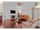 The open living room features a fireplace, tv, hardwood floors, and natural lighting at 909 Jordans Pond Ln, Charlotte, NC 28214