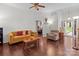 Bright living room with hardwood floors features a comfy sofa, loveseat, and lots of natural lighting at 909 Jordans Pond Ln, Charlotte, NC 28214