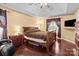 Spacious main bedroom has a trey ceiling, hardwood floors, and natural lighting at 909 Jordans Pond Ln, Charlotte, NC 28214