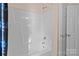 Bathroom shower featuring white molded shower with chrome fixtures and door at 909 Jordans Pond Ln, Charlotte, NC 28214