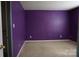 Bedroom with a vibrant purple wall color and carpeted floors, ready for personalization at 9109 Foggy Meadow Rd, Charlotte, NC 28269