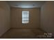 Bedroom with a window and carpeted floors, perfect for a cozy atmosphere at 9109 Foggy Meadow Rd, Charlotte, NC 28269