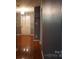 Hallway with hardwood floors leading to the front door, adjacent to other rooms at 9109 Foggy Meadow Rd, Charlotte, NC 28269