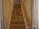 Carpeted stairway with wooden handrail provides access to the upper levels of the home at 9109 Foggy Meadow Rd, Charlotte, NC 28269