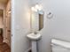 Bathroom with a pedestal sink, octagonal mirror and wall-mounted towel rack at 9134 Northfield Crossing Dr, Charlotte, NC 28269