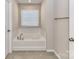 Bathroom features a soaking tub with tile surround, chrome fixtures, and natural light at 9134 Northfield Crossing Dr, Charlotte, NC 28269