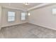 Spacious bedroom featuring neutral carpet and multiple windows at 9134 Northfield Crossing Dr, Charlotte, NC 28269