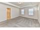 Spacious bedroom featuring neutral carpet and multiple windows at 9134 Northfield Crossing Dr, Charlotte, NC 28269