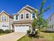 Charming two-story home with a stone accent garage, neutral siding, a tree, and a well-manicured lawn at 9134 Northfield Crossing Dr, Charlotte, NC 28269