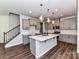 Well-designed kitchen with a center island, stylish lighting, sleek stainless steel appliances, and ample cabinetry at 9134 Northfield Crossing Dr, Charlotte, NC 28269