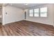 Bright living room featuring wood floors and natural light from multiple windows at 9134 Northfield Crossing Dr, Charlotte, NC 28269