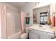 Inviting bathroom features a shower/tub combo with a peach curtain and coordinated towels at 1015 Gardenia Dr # 52, Mt Ulla, NC 28125