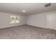 Expansive bonus room with plush carpet, natural light, and neutral walls at 1015 Gardenia Dr # 52, Mt Ulla, NC 28125