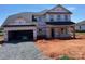 New two-story home featuring an attached two car garage and covered front porch in a residential area at 1015 Gardenia Dr # 52, Mt Ulla, NC 28125