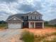 Charming two-story home with a large two-car garage and inviting front porch at 1015 Gardenia Dr # 52, Mt Ulla, NC 28125