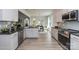 Modern kitchen boasting stainless steel appliances, white cabinets, granite countertops, and an open layout at 1015 Gardenia Dr # 52, Mt Ulla, NC 28125