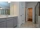 Bathroom features double sink vanity with walk in closet access at 10209 Meeting House Nw Dr, Huntersville, NC 28078