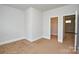 Bedroom with neutral carpet, white trim, and doorway to the closet at 10209 Meeting House Nw Dr, Huntersville, NC 28078