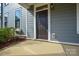 Exterior shot highlighting the home's front door, windows, and neat landscaping at 10209 Meeting House Nw Dr, Huntersville, NC 28078