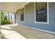 Relaxing covered front porch of a townhome featuring two large windows and space for seating at 10209 Meeting House Nw Dr, Huntersville, NC 28078