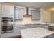 Gourmet kitchen showcases granite counters, stainless steel appliances, and grey cabinetry at 10209 Meeting House Nw Dr, Huntersville, NC 28078