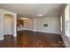 Spacious living room featuring elegant hardwood floors, crown molding, and ample natural light at 10209 Meeting House Nw Dr, Huntersville, NC 28078