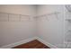 Walk-in closet with wire shelving and wood-look flooring at 10209 Meeting House Nw Dr, Huntersville, NC 28078