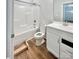 Clean white bathroom featuring a tub-shower combo, vanity sink, and modern fixtures on wood-look flooring at 1035 Gardenia Dr # 51, Mt Ulla, NC 28125