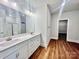 Modern bathroom with double sinks, wood floors, and a walk-in closet entrance at 1035 Gardenia Dr # 51, Mt Ulla, NC 28125