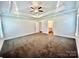 Spacious main bedroom featuring a tray ceiling with a ceiling fan and an ensuite bath at 1035 Gardenia Dr # 51, Mt Ulla, NC 28125
