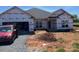 New construction home featuring a two-car garage, well-lit windows, and a modern roof design at 1035 Gardenia Dr # 51, Mt Ulla, NC 28125
