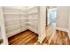 Walk-in closet featuring built-in shelving and wood floors at 1035 Gardenia Dr # 51, Mt Ulla, NC 28125