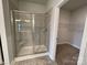 Modern bathroom featuring a glass-enclosed shower with tiled walls, a built-in bench, and updated fixtures at 1050 Gardenia Dr # 3, Mt Ulla, NC 28125