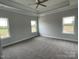 Spacious bedroom with tray ceiling, ceiling fan and plush carpet, offering comfort and style at 1050 Gardenia Dr # 3, Mt Ulla, NC 28125