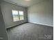 Comfortable bedroom with plush carpeting and natural light streaming through the window at 1050 Gardenia Dr # 3, Mt Ulla, NC 28125