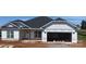 Charming one-story home featuring a two-car garage, white siding, and a dark shingled roof ready for its new owners at 1050 Gardenia Dr # 3, Mt Ulla, NC 28125