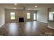 Bright living room with a fireplace, large windows, and hardwood flooring offering ample natural light at 1050 Gardenia Dr # 3, Mt Ulla, NC 28125