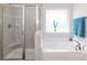 Luxurious bathroom features a walk-in shower, soaking tub, and window for a spa-like experience at home at 1070 Gardenia Dr # 4, Mt Ulla, NC 28125
